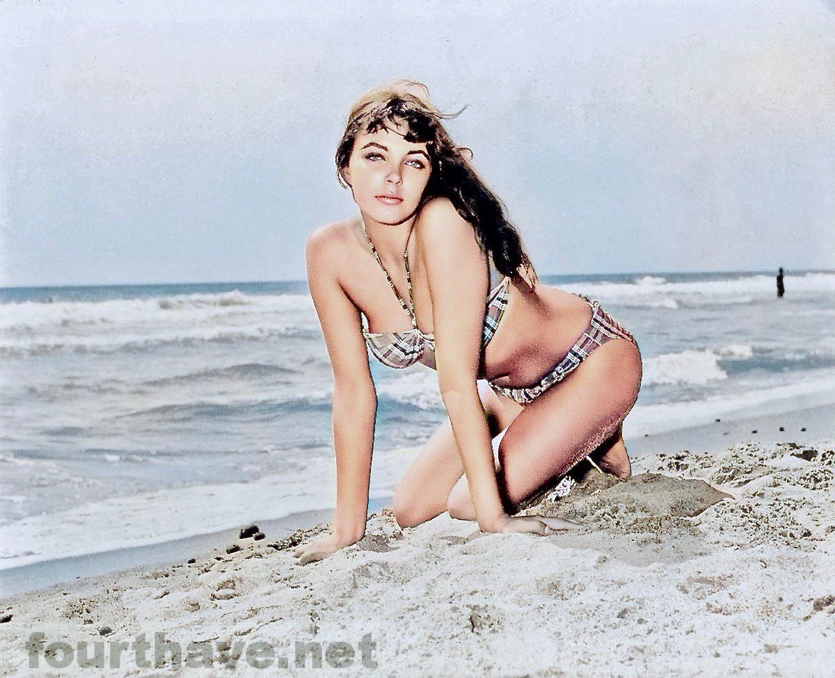 Joan Collins in a sexy pose on the beach