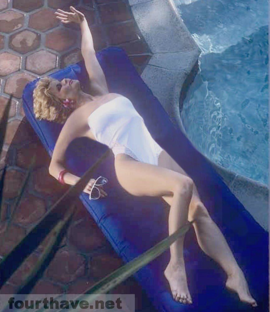 Markie Post in white by the pool